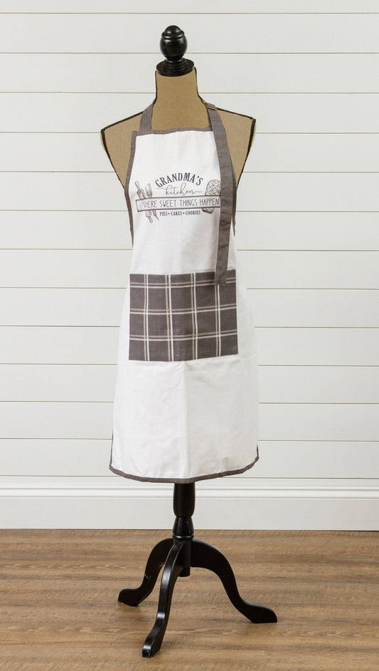 White apron with plaid design on a mannequin against a wooden floor and white wall background